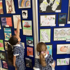 students looking at pictures on a board