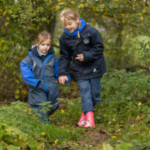 girls walking through the forest